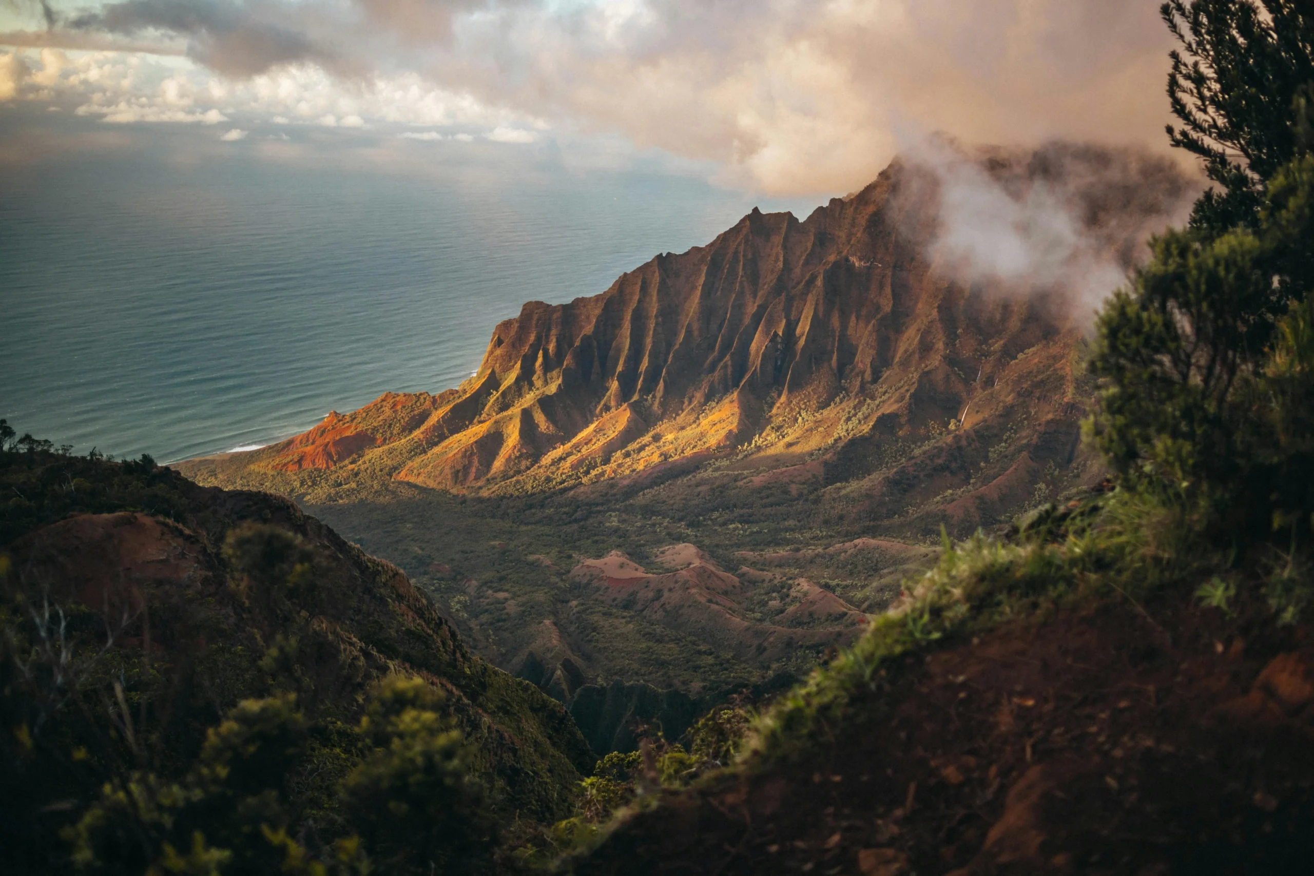 A breathtaking mountain ridge meeting the ocean, symbolizing Erain Mercantile’s harmony with nature and commitment to bold, lasting impact.