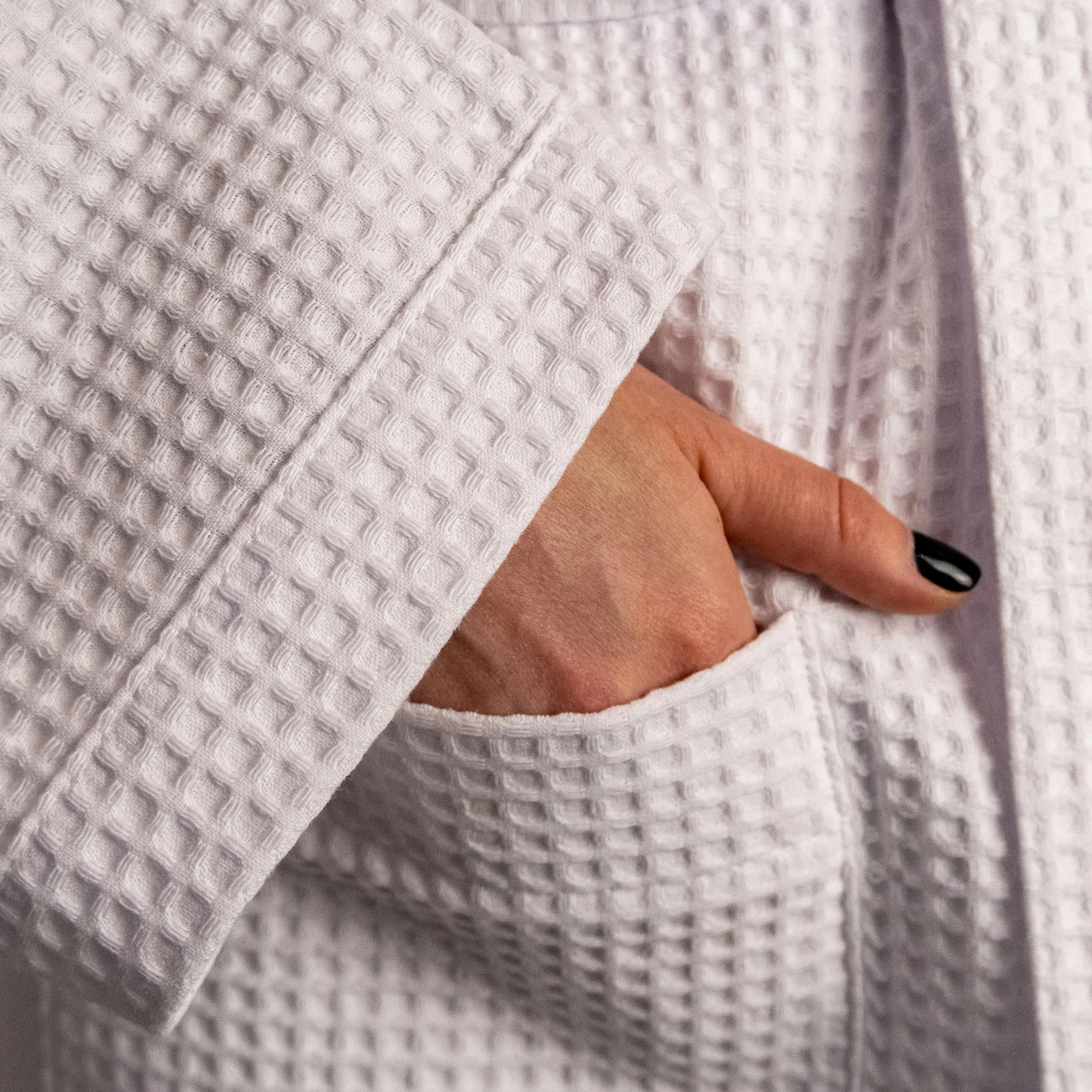 Close-up of hand in waffle robe pocket – luxury skincare and personal care wear